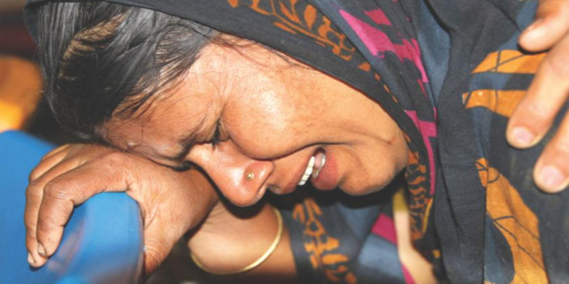 Wife of a Day Laborer Sobbed Fitfully at the Sight of the Charred Body of Her Husband